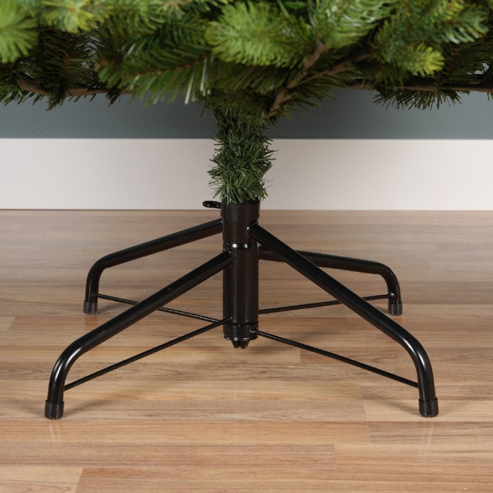 A sturdy black metal stand supporting a lush green artificial Christmas tree.