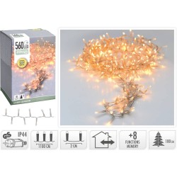 A coil of warm white LED string lights beside their packaging, featuring a soft glow.