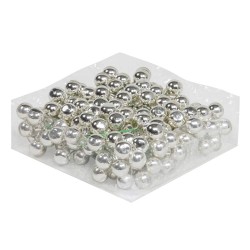 A cluster of shiny silver balls arranged neatly on a clear plastic sheet.