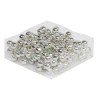 A cluster of shiny silver balls arranged neatly on a clear plastic sheet.