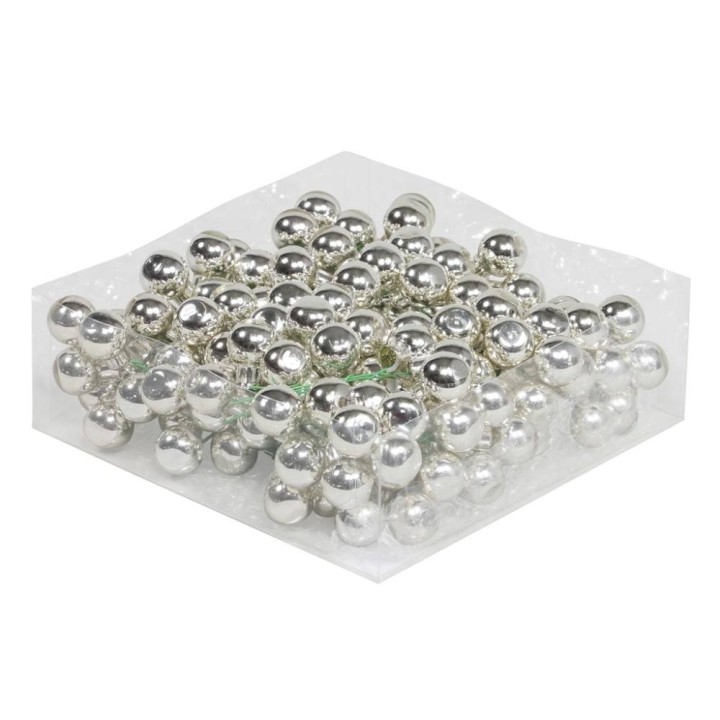 Glanzende zilveren bolletjes op een doorzichtige ondergrond, knisperend in het licht.