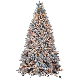 A frosted artificial Christmas tree, lush and layered, adorned with warm glowing lights.