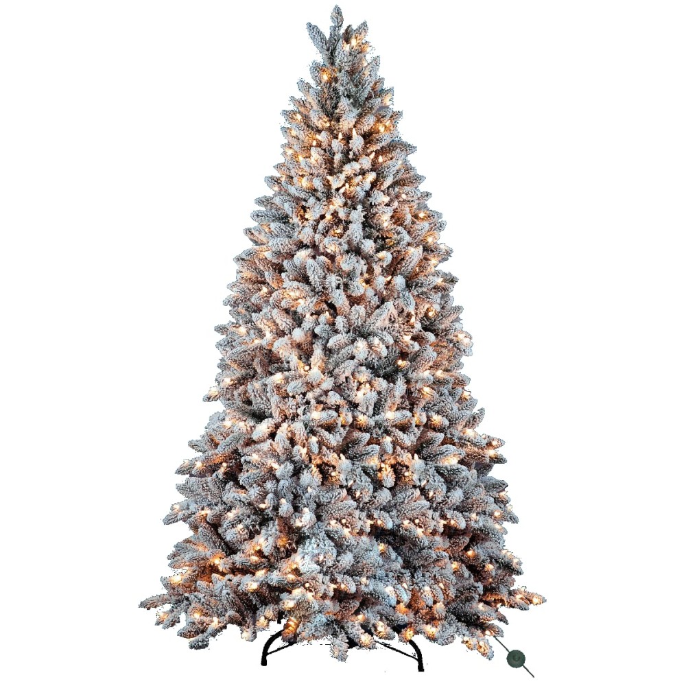A frosted artificial Christmas tree, lush and layered, adorned with warm glowing lights.