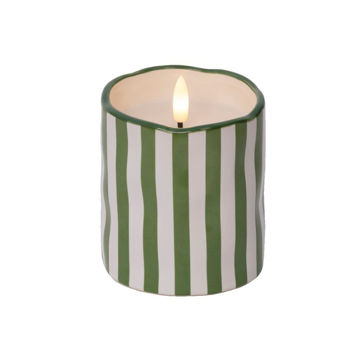 A green and white striped candle with a flickering flame atop a wavy edge.
