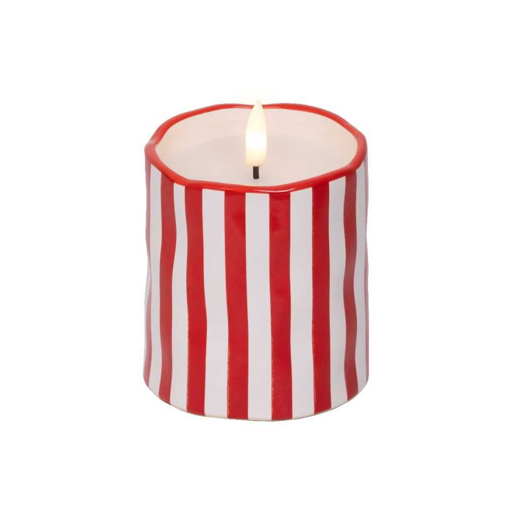 Bougie ronde aux rayures rouges et blanches, flamme vacillante au centre.