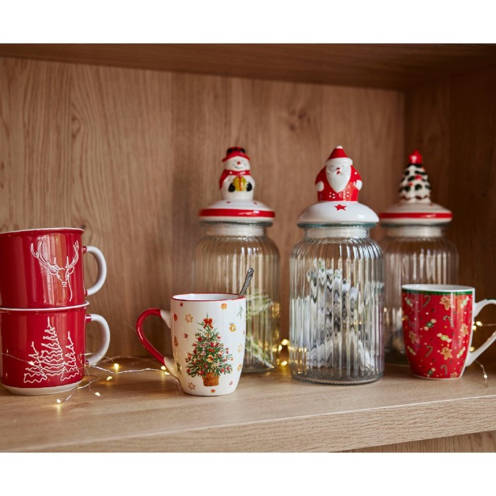 A cozy shelf adorned with festive mugs and jars, featuring cheerful holiday designs.