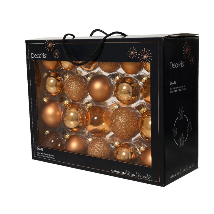 Een zwarte doos met doorzichtige voorkant vol gouden kerstballen in diverse vormen en glans.