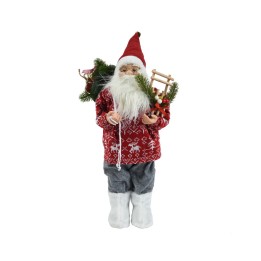 Poupée de Noël avec pull rouge, traîneau miniature et décorations végétales.