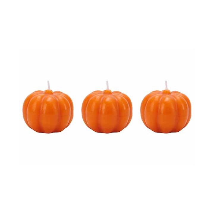 Three small, glossy orange pumpkin candles with ridged surfaces and white wicks.