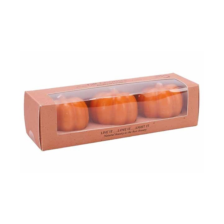 Three small, orange pumpkin-shaped candles in a clear box with a brown paper base.