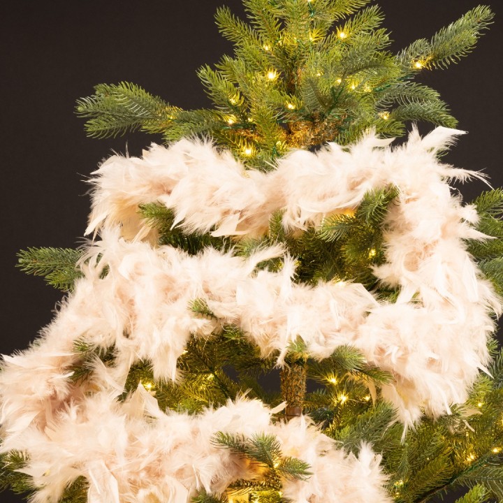 A festive Christmas tree adorned with soft, fluffy white garland and warm twinkling lights.