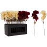 A black box holds vibrant faux flowers in rich red and soft cream, with delicate stems.