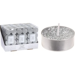 A silver candle with sparkles next to a box of matching tealights.