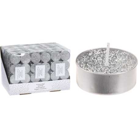 A silver candle with sparkles next to a box of matching tealights. A silver candle with sparkles next to a box of matching tealights.