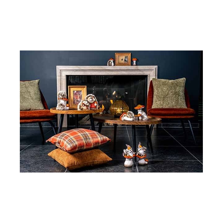 Cozy living room scene with plush chairs, rustic tables, and playful decorative figures.