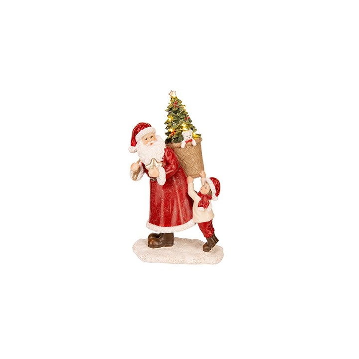 A cheerful Santa in red robes carries a tree while a boy assists, evoking holiday spirit.