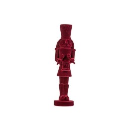 A vibrant red nutcracker figure with a tall hat and expressive face, standing on a circular base.