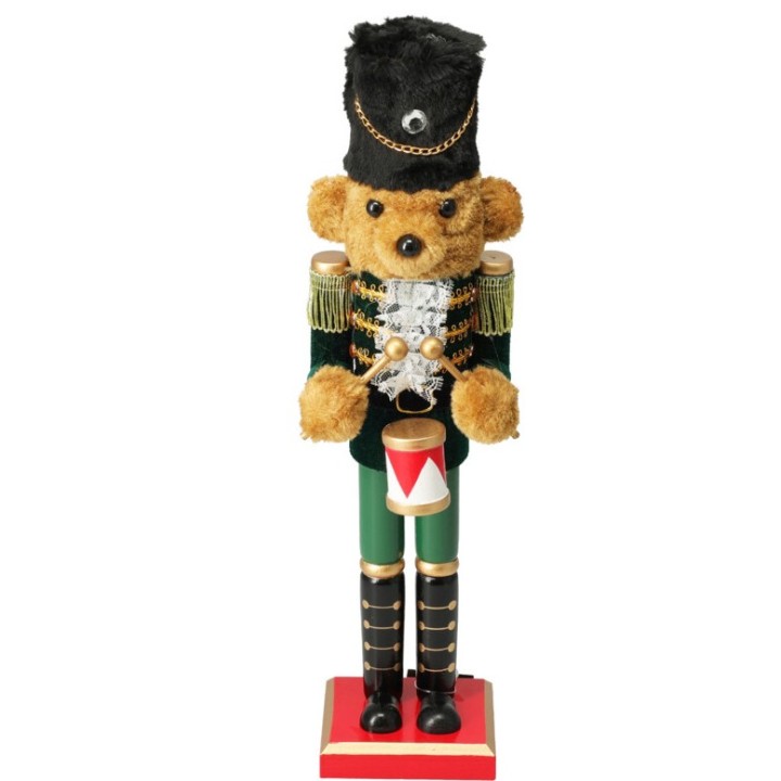 A teddy bear dressed as a toy soldier, adorned with gold accents and a furry hat.