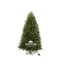 A lush green artificial Christmas tree adorned with warm white lights.