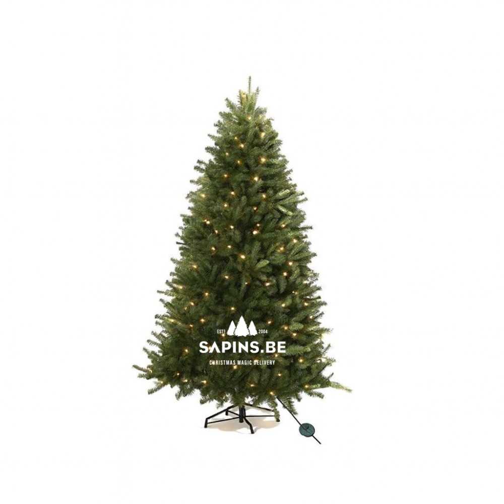 A lush green artificial Christmas tree adorned with warm white lights.