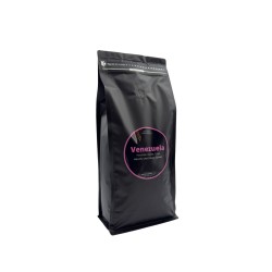 A sleek black coffee bag with a bold pink label reading "Venezuela."