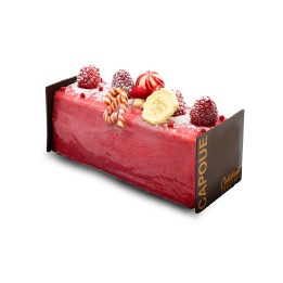 A vibrant red mousse cake topped with fresh berries and festive candy canes.
